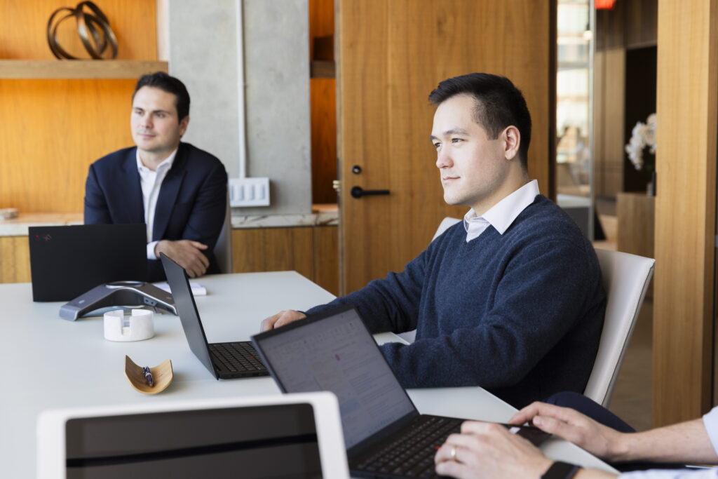 two people sitting at a table listening
